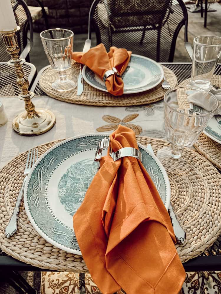 Vintage Currier & Ives Blue Dishes with burnt orange napkins and cookie cutter napkin rings.  