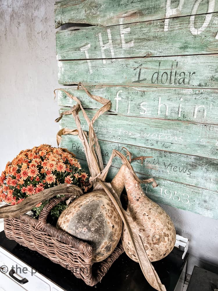 DIY Vintage Sign and Gourdes add to the outdoor kitchen decor