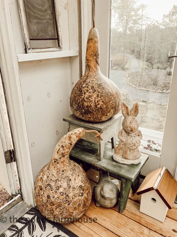Gourdes and vintage garden statues with vintage DIY birdhouses for fall in the She Shed Ideas.