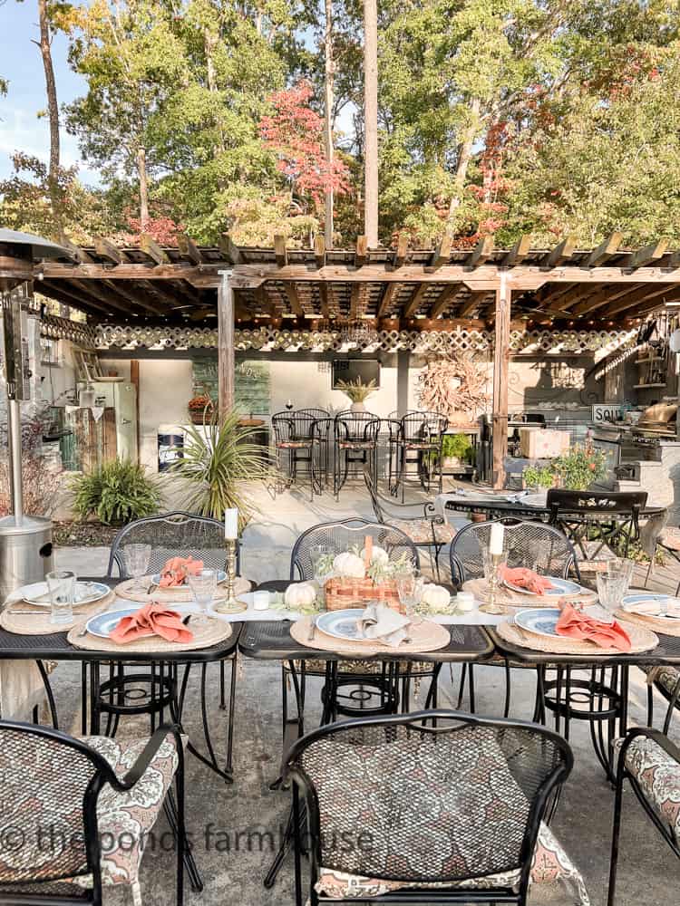 View of table setting and outdoor Kitchen decorated for Fall Pulled Pork Nacho Dinner Party.