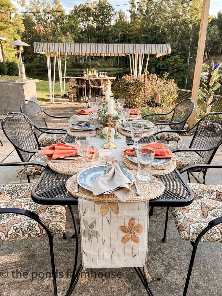 Hand-painted table runner made of drop cloth fabric matches the outdoor seat cushions for a Fall Dinner Party