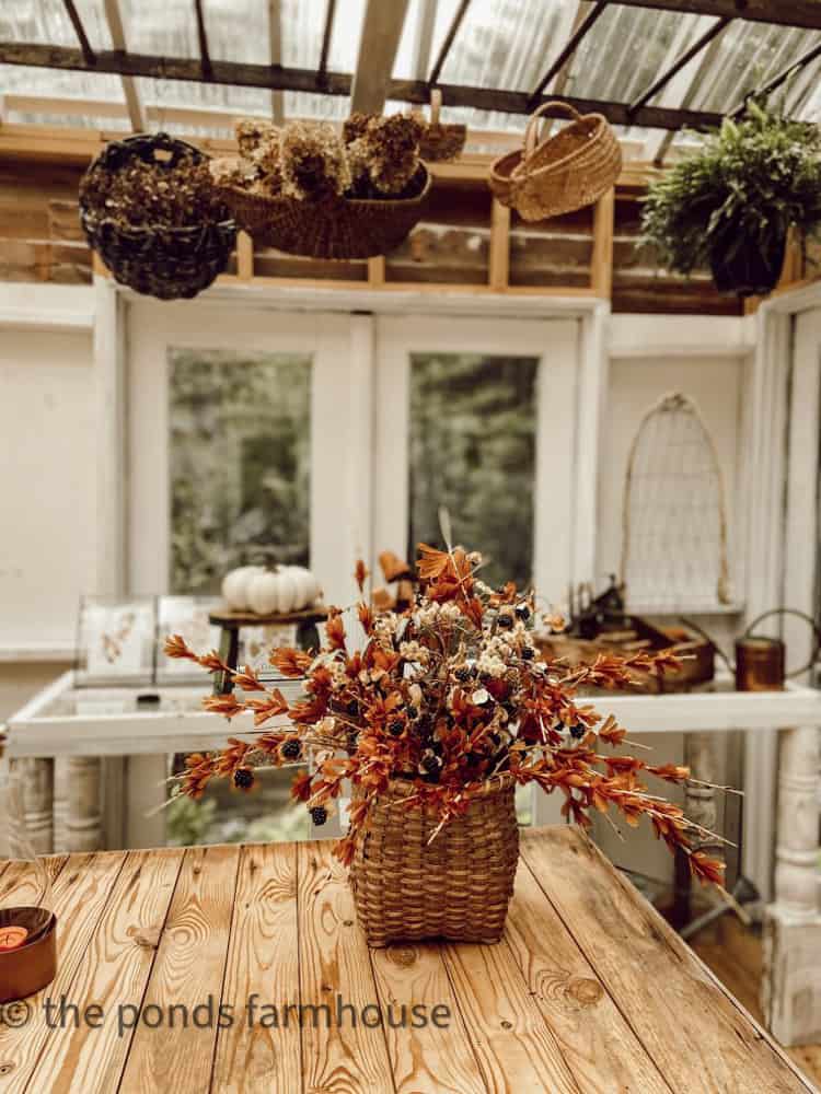 Wooden Ladder Decor in she shed and greenhouse with fall basket arrangement.