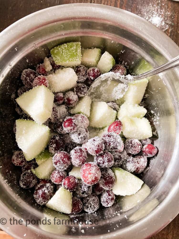 Add sugar to coat the fresh cranberries and chopped Apples in this delicious holiday recipe