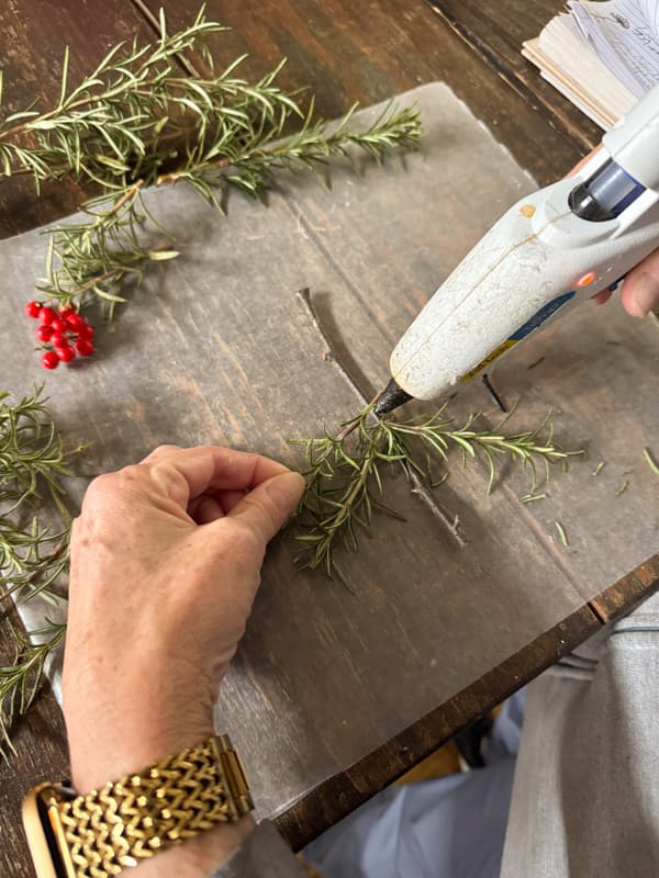 add rosemary stems to twig with hot glue