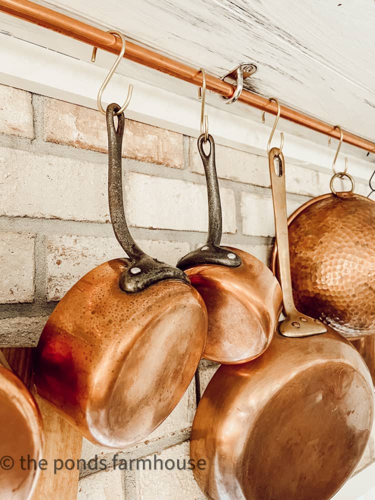 S hooks to hang vintage copper pots on rack.