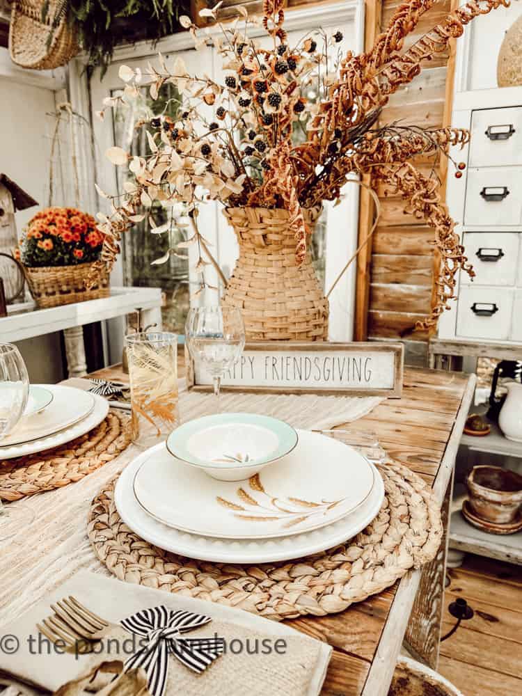 Dried Floral Arrangement in thrift store woven basket vase on Friendsgiving Brunch Table Setting