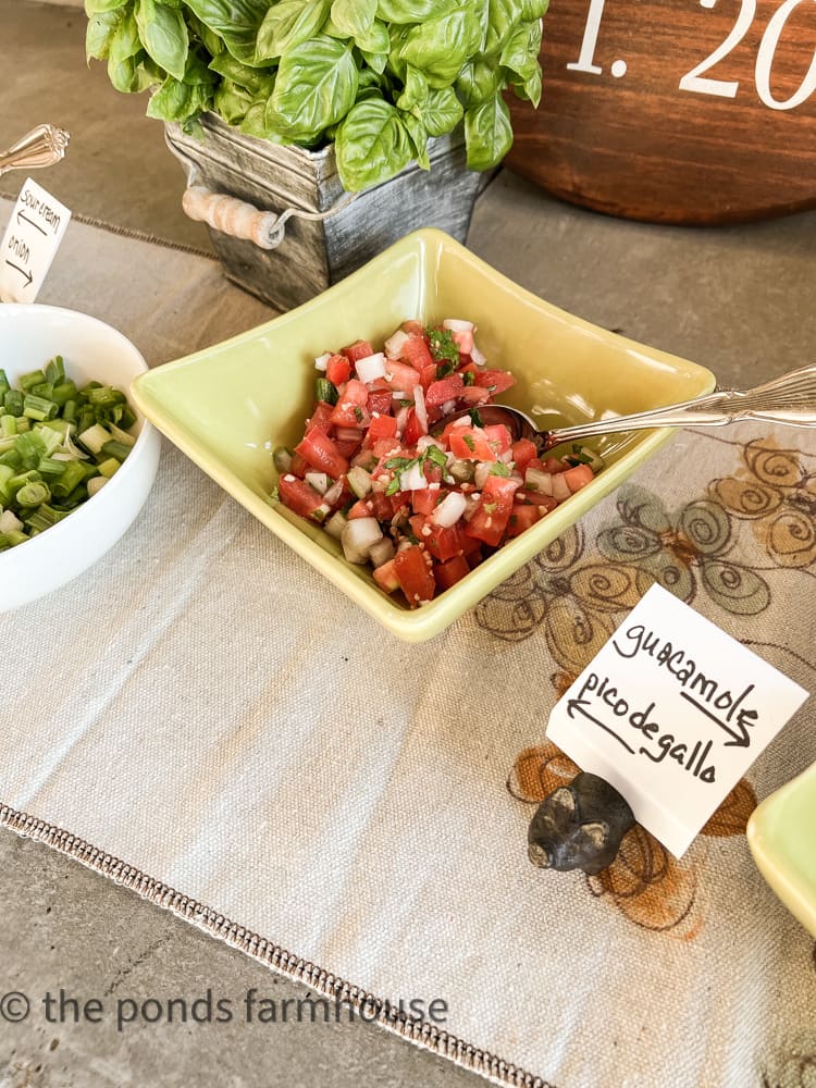 Topping for pulled pork nachos recipe and serving suggestions.  Guacomole and pico de gallo 