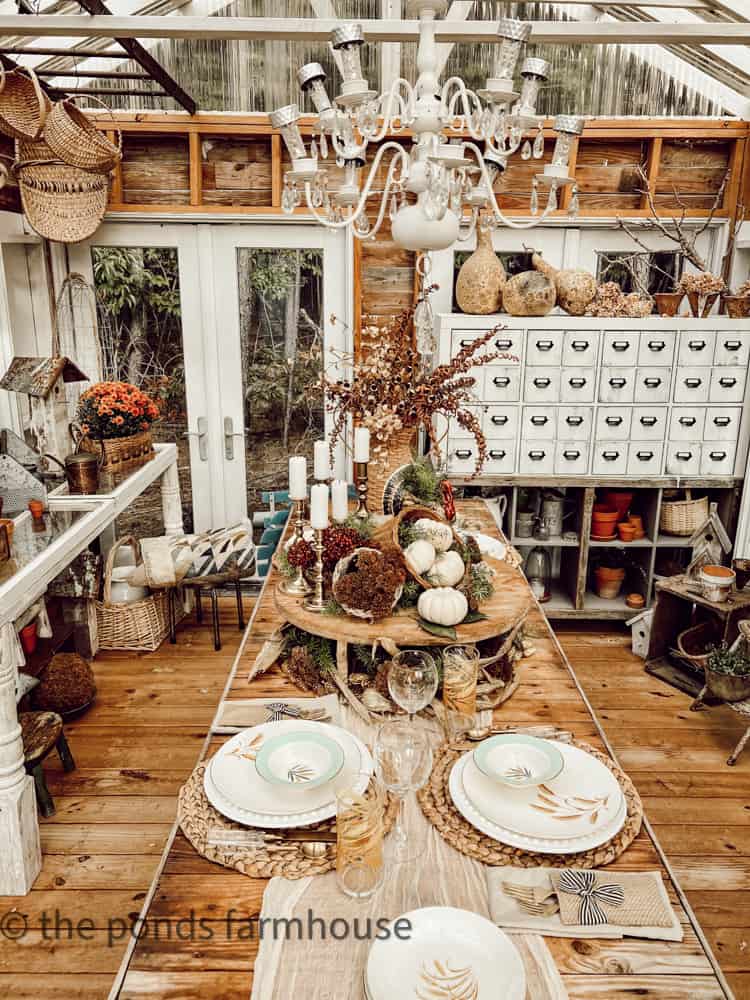 Repurposed Chandelier over Friendsgiving Brunch Table with pumpkins, dried flowers and wheat plates