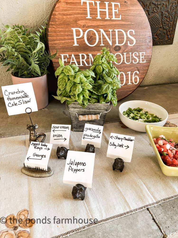 Place card held by mini pigs for nacho party.  