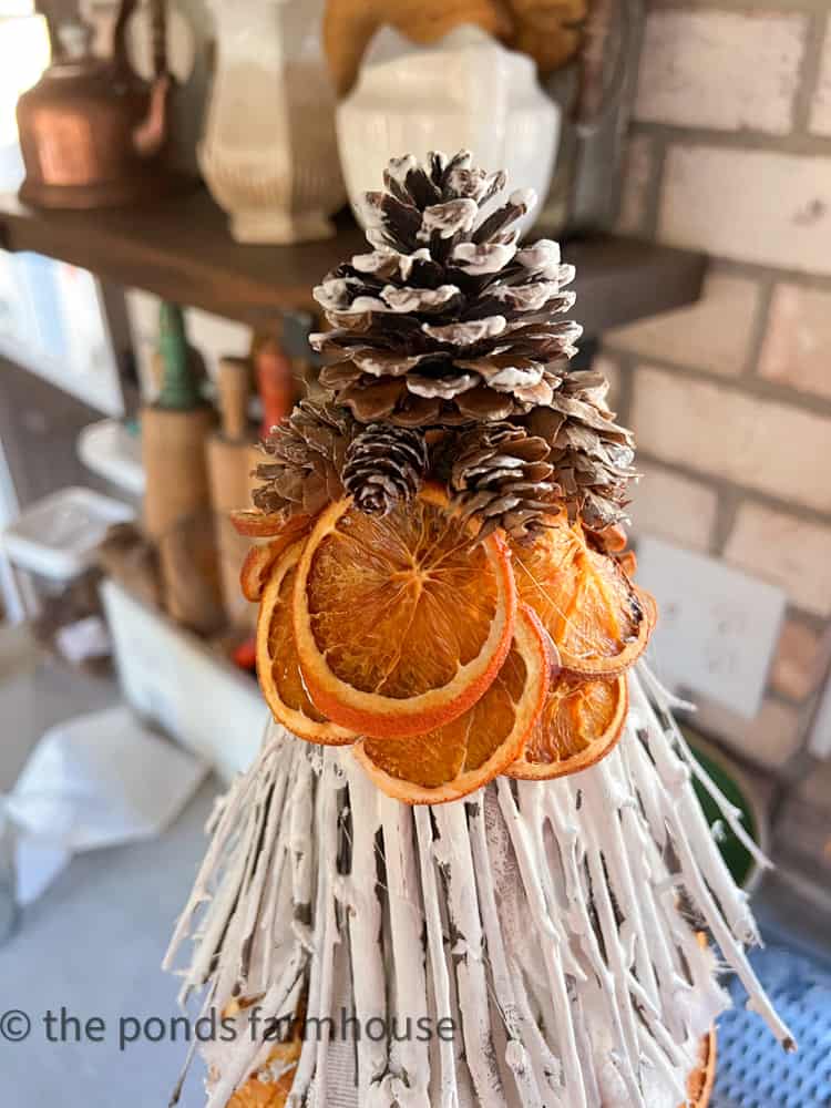 Foraged pinecones and dried oranges for sustainable DIY Christmas Topiaries.