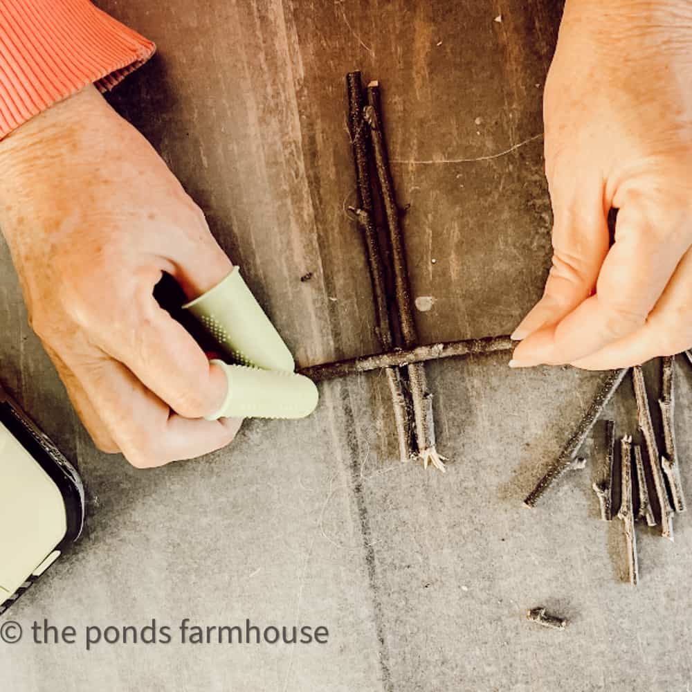 Use hot glue gun to attach twigs together for eco-friendly Christmas Ornaments