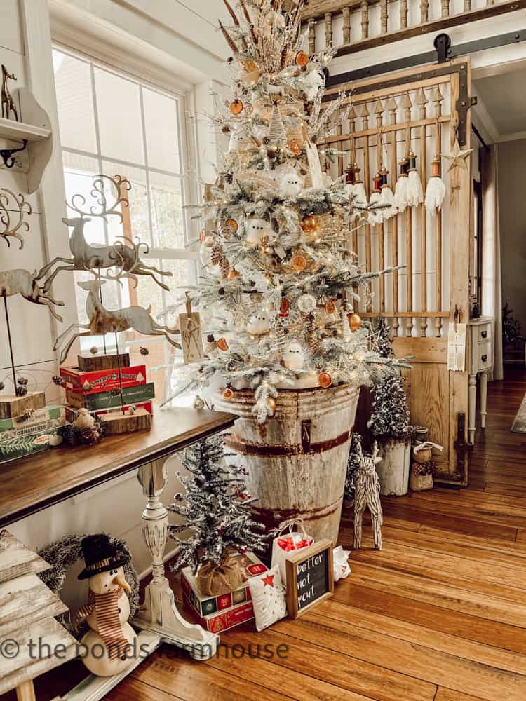 Woodland theme budget-friendly Christmas tree in European Olive Barrel Tree container.