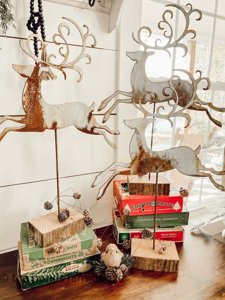 trio of metal reindeer on top of vintage Christmas Ornament Boxes.  Vintage Shiny Brite Boxes