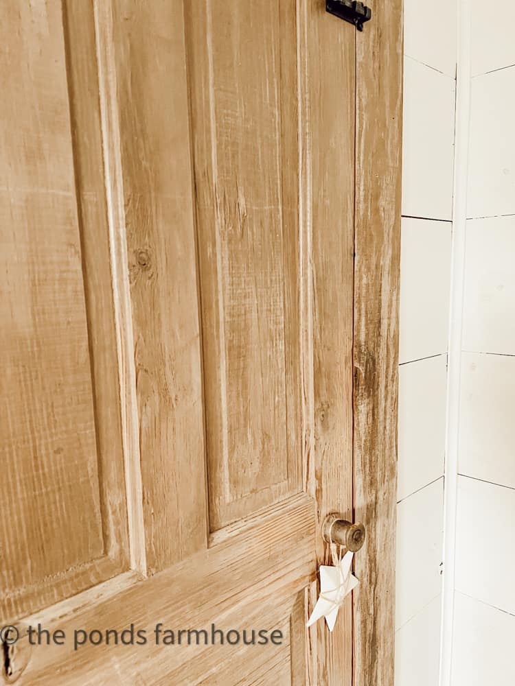 Old door with wooden spool as door knob.  