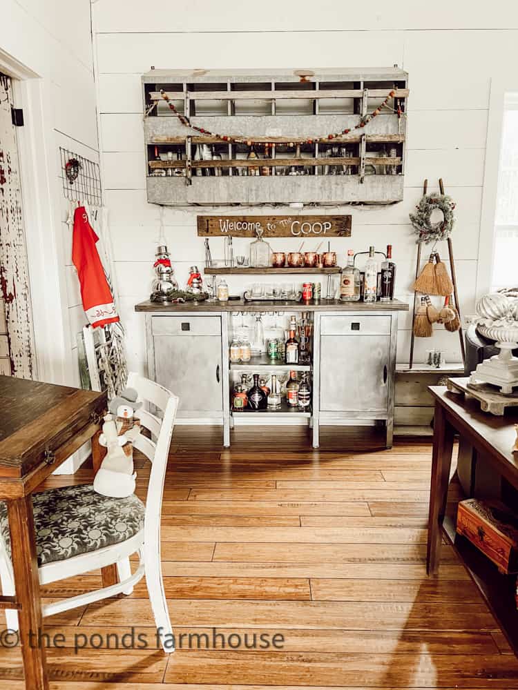 Industrial style loft bar with vintage chicken nesting box and repurposed hospital carts as bar.