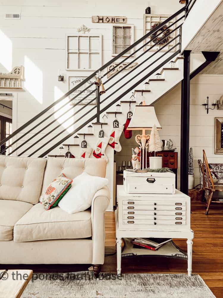 Industrial Modern Farmhouse Living Room and Stair Case with wrought iron banister and gallery wall.