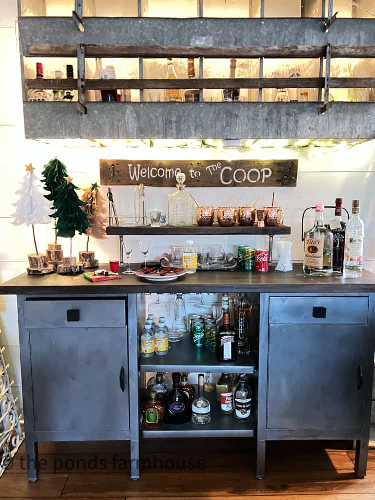 Repurposed Hospital Carts and Nesting Box serve as a bar in the loft of the industrial style farmhouse.