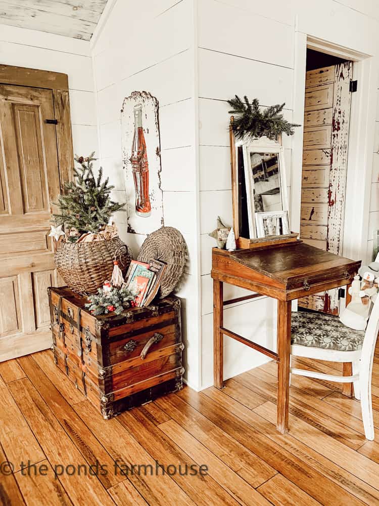 Old Trunk with Antique Coke Sign and handcrafted wood desk and thrifted chair.  Layers of mirrors over desk.