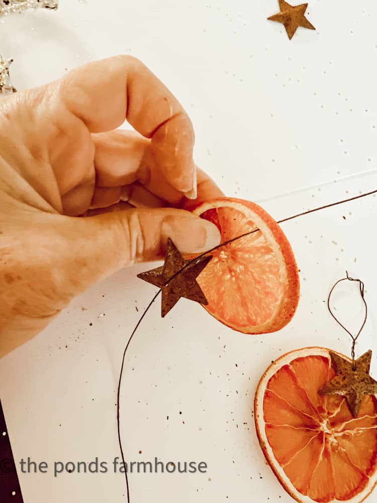 String dried orange with rustic wire and rusty metal star for rustic Christmas Tree decor.