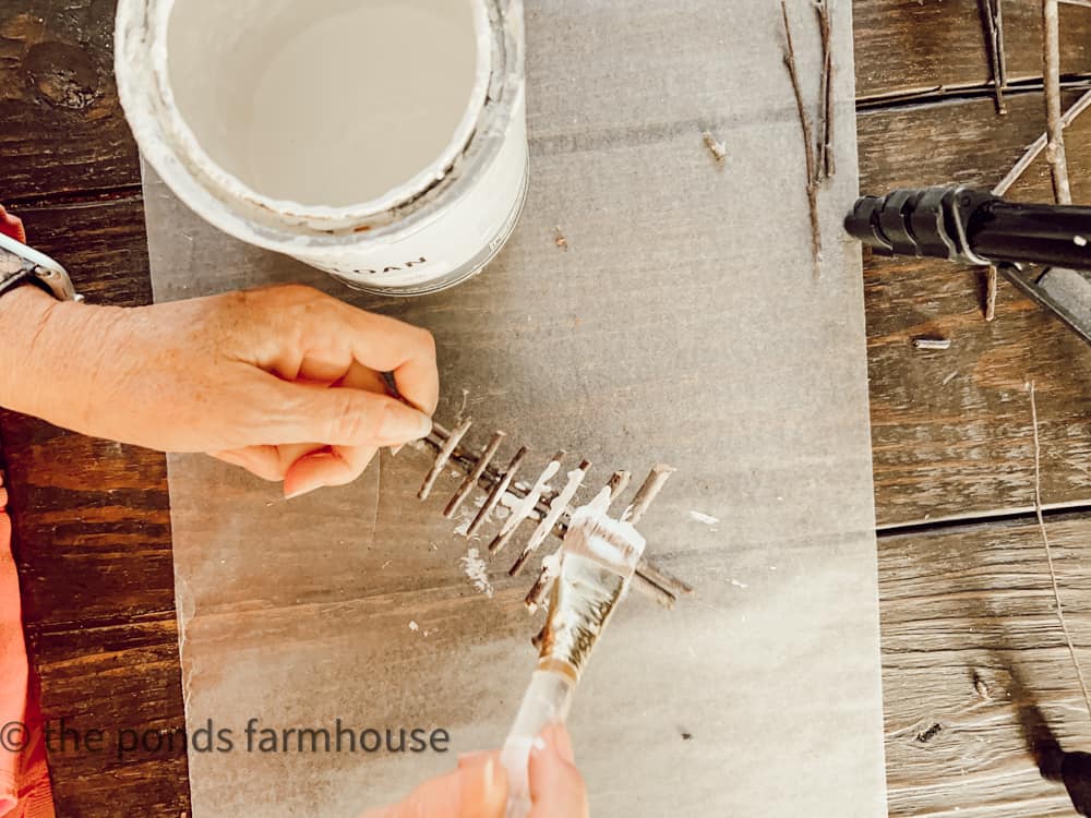 Painting Foraged Eco-friendly and sustainable Christmas tree ornaments.