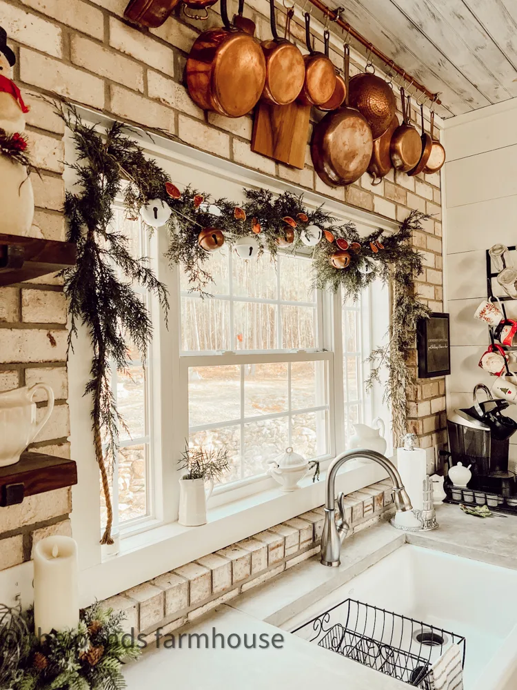 vintage Copper DIY Hanging pot rack and cedar garland with dried oranges and repurposed Dollar Tree Bells.