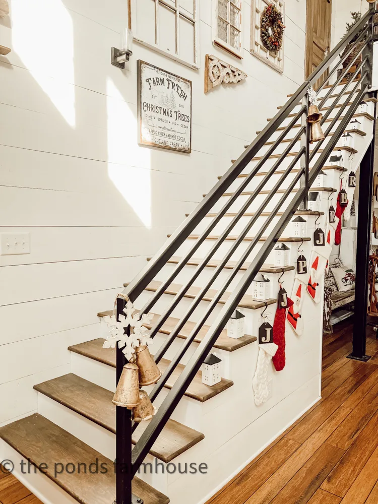 Wrought iron banister for industrial style loft staircase with a gallery wall of vintage architectural finds