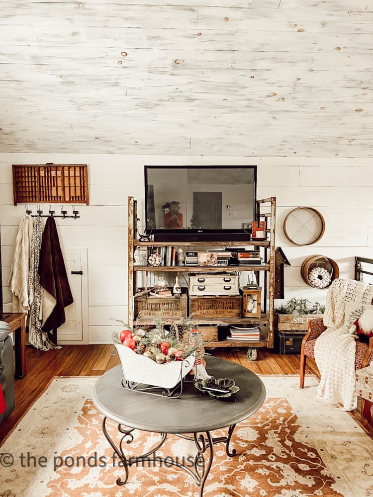 Industrial Style Loft holds a old commercial cart repurposed as a TV Stand.  