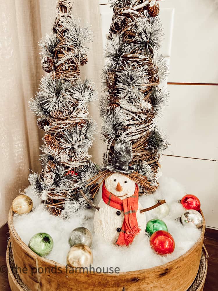 grapevine and pinecone Christmas trees, inside wooden vintage sifter and paper mache snowman with shiny brite ornaments.
