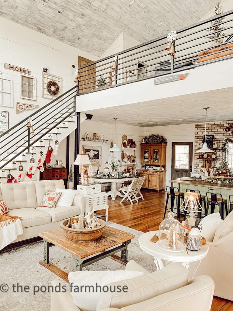 View of vintage loft decorated for Christmas from front entry of Industrial style farmhouse