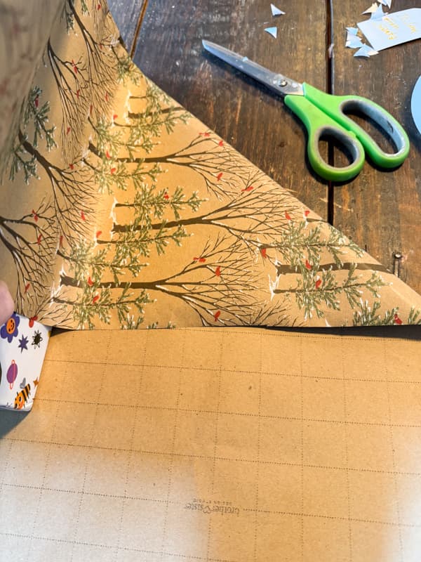 fold the side of the paper against the package creating two triangles.  