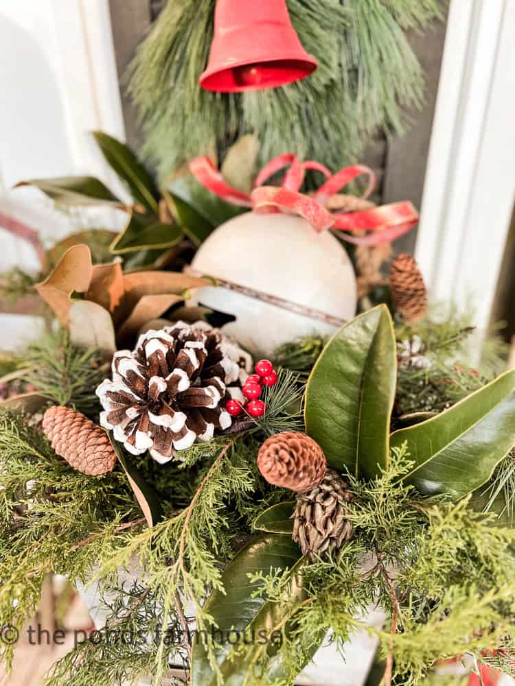 Cedar, pinecones, magnolia leaves and large bell fill the DIY planters