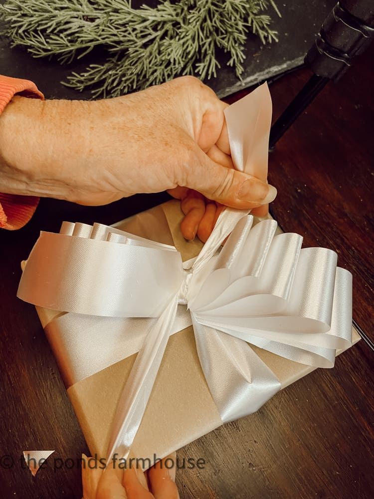 Tie the bow onto the gift package