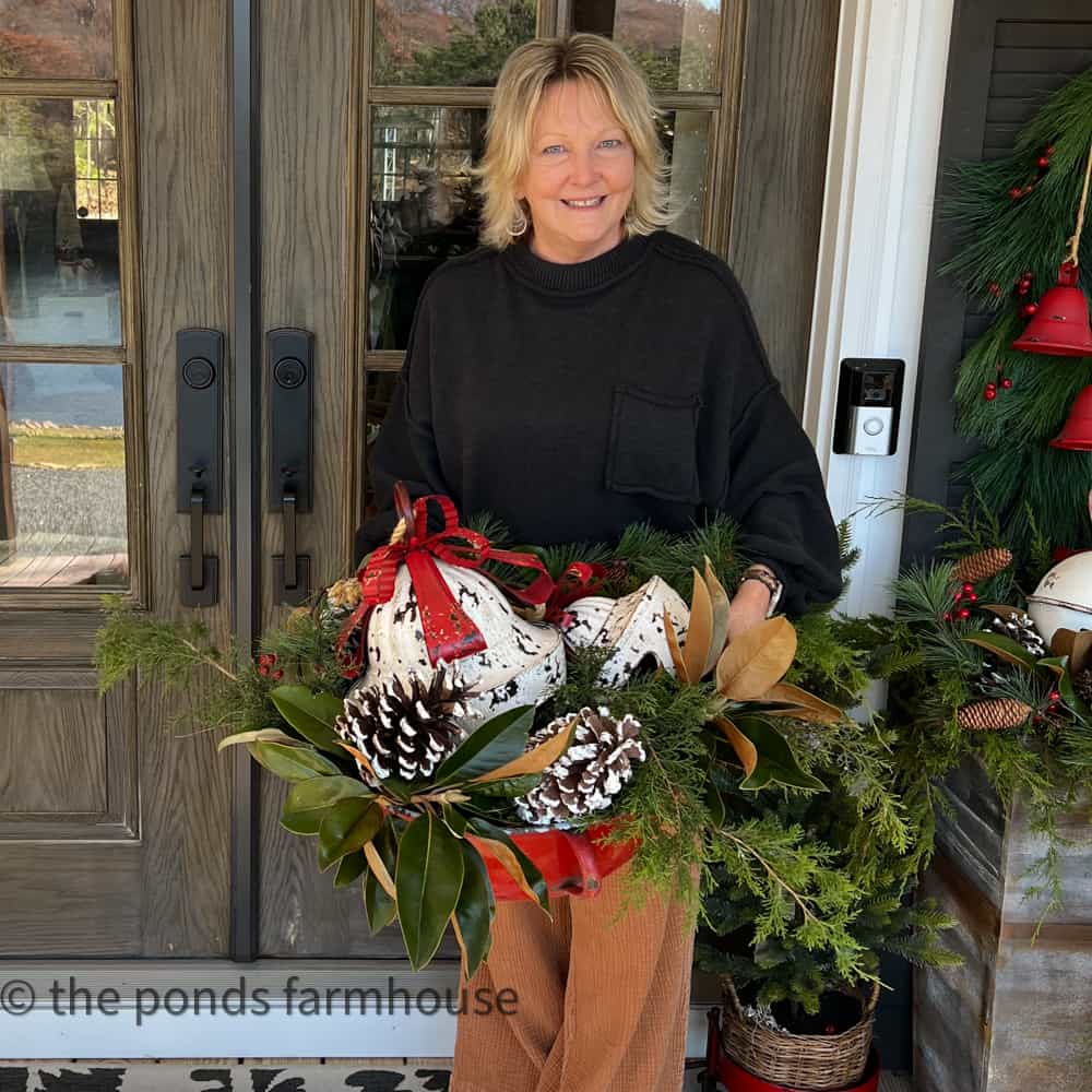 Budget Christmas Decorating Ideas for a festive front porch with natural greenery and collected Christmas decorations.