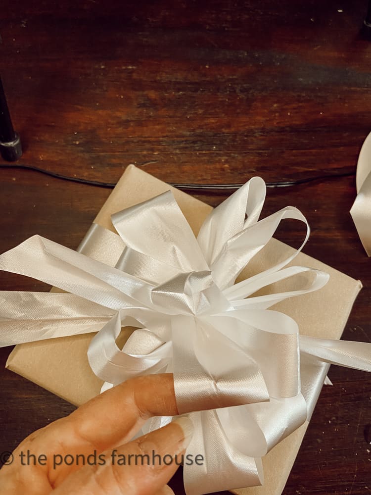 How to Tie a Gift Bow perfectly every time. Easy instructions to make your holiday gifts look professionally wrapped.