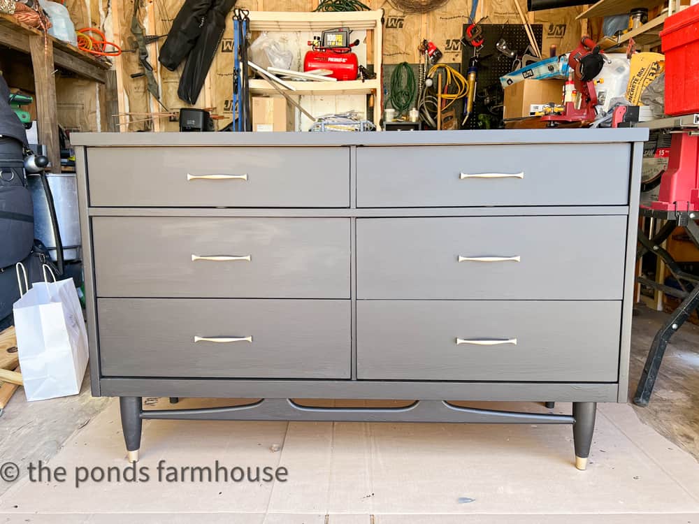 Matte Black chalk paint and antique brass paint updated this mid-century furniture dresser.