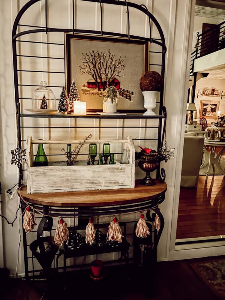 Bakers rack filled with vintage and thrift store finds for Farmhouse Christmas Candlelight Tour.