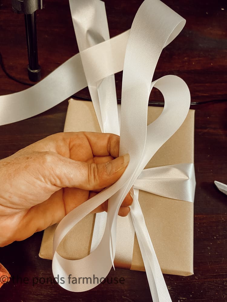 Fold ribbon to make gift package bows