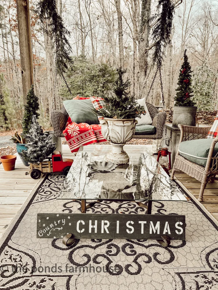 Seating area on front porch decorated for Christmas tour.