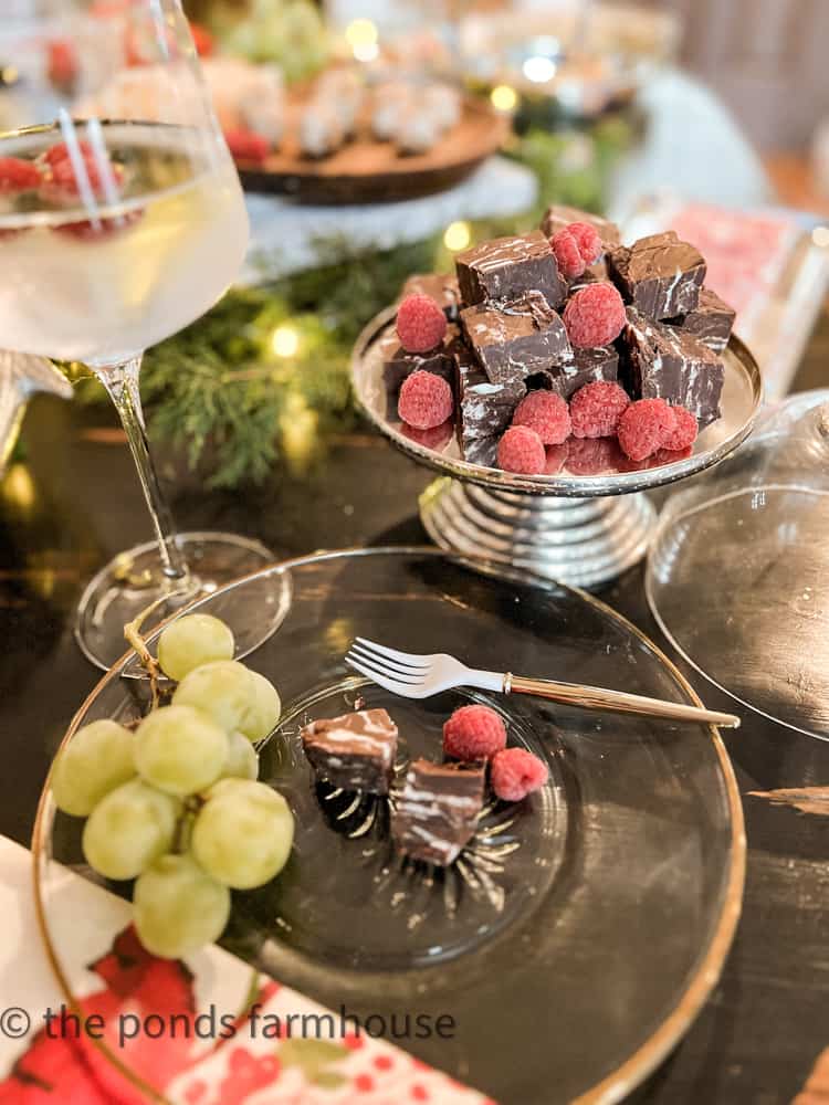 Plate and dessert tray filled with raspberries and dark chocolate raspberry fudge