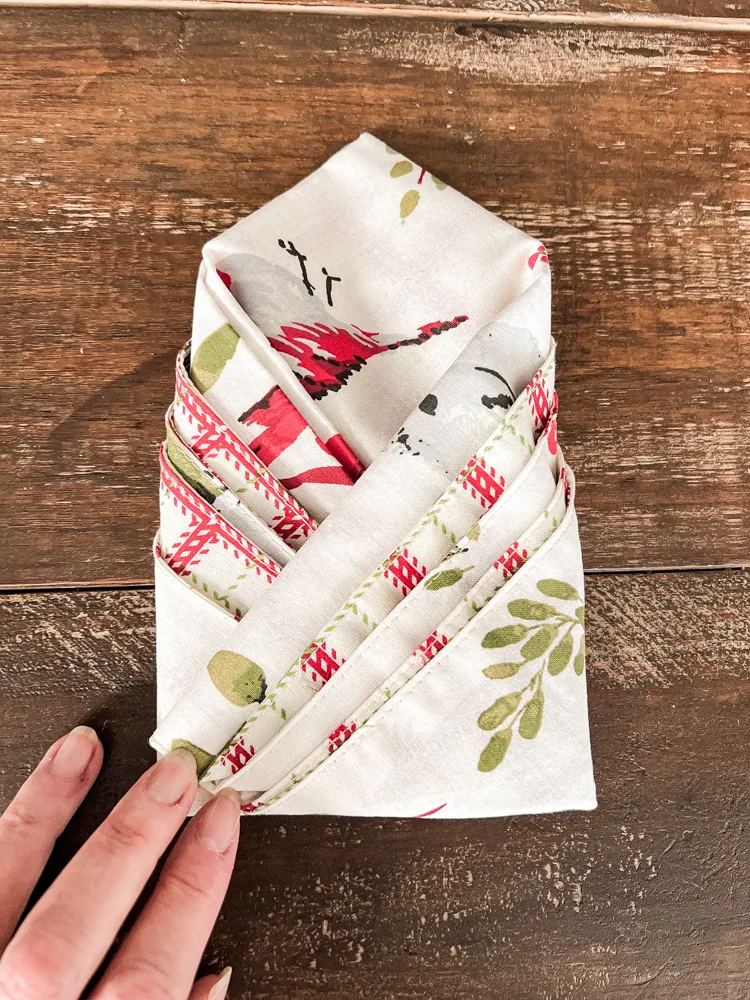 How to fold a cutlery pocket napkin with a reversible print napkin.