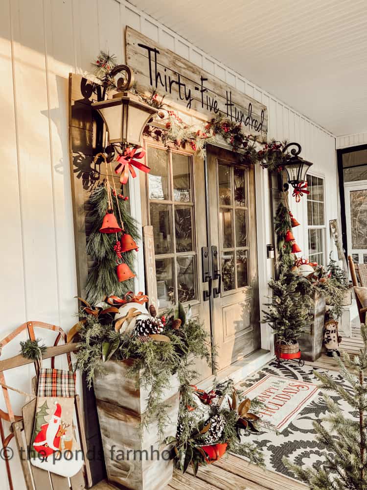 Front Doors decorated for Christmas with DIY planters filled with greenery and pinecones foraged from property.