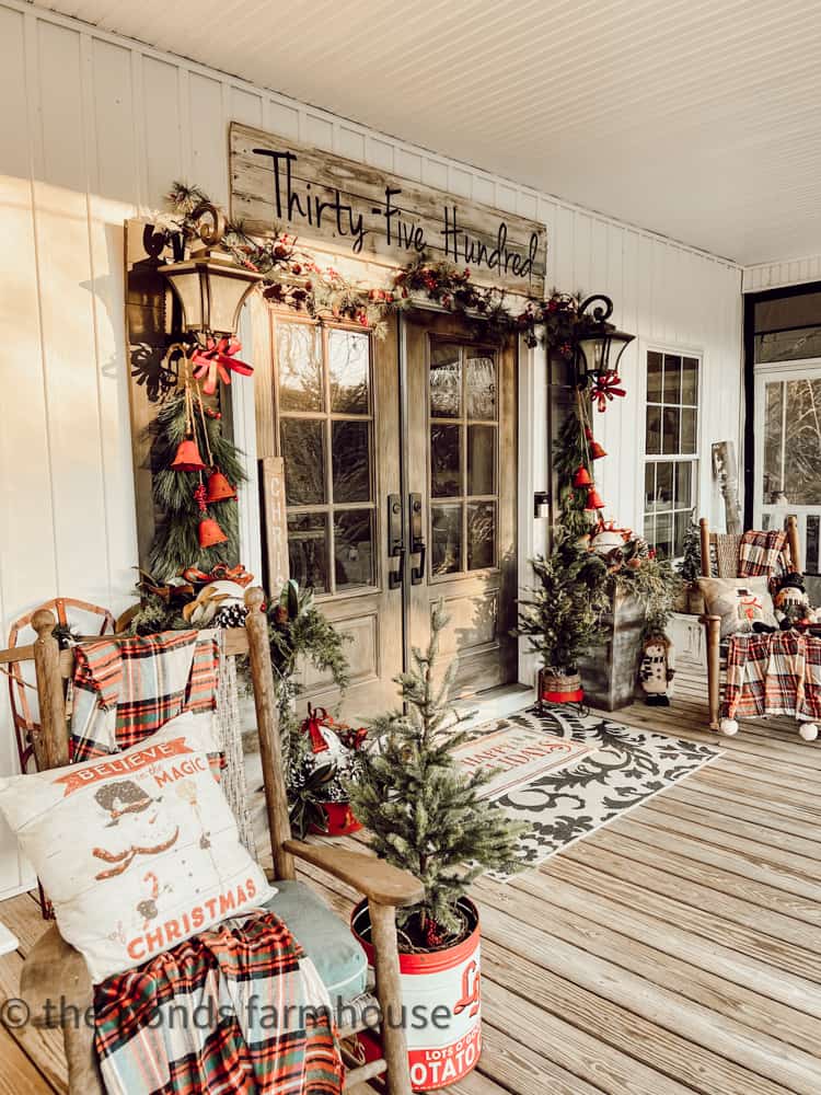 Farmhouse Porch decorated for Christmas Tour with rocking chairs and vintage decor.