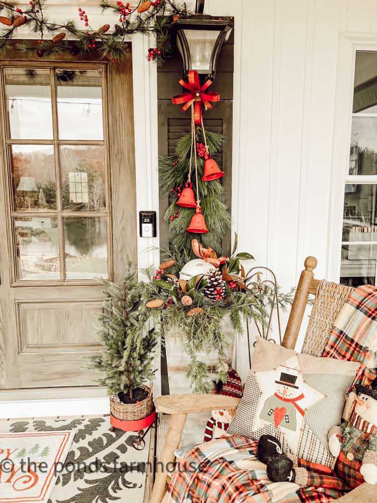 Farmhouse Porch Decorated for Christmas with foraged greenery and DIY projects.