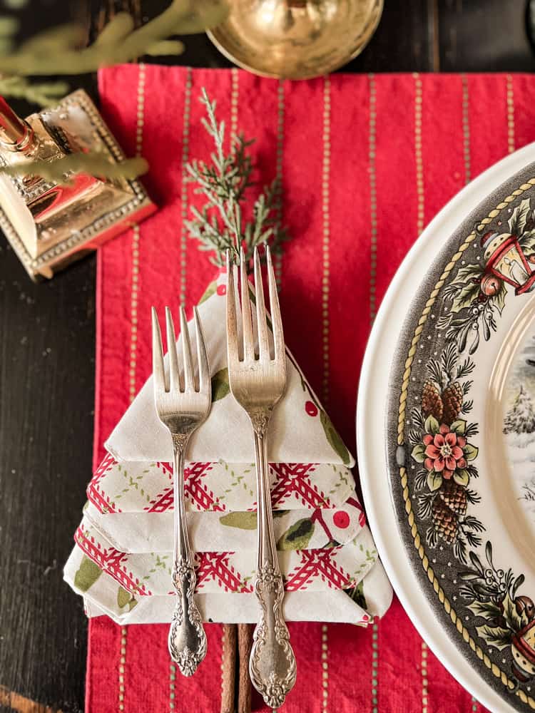 Napkin Christmas Tree Fold with silverware on top of the napkin for a Holiday Tablescape.