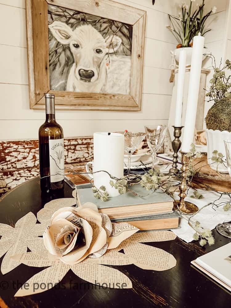 Cow Painting and old books make up a fun tablescape for a farmhouse party.