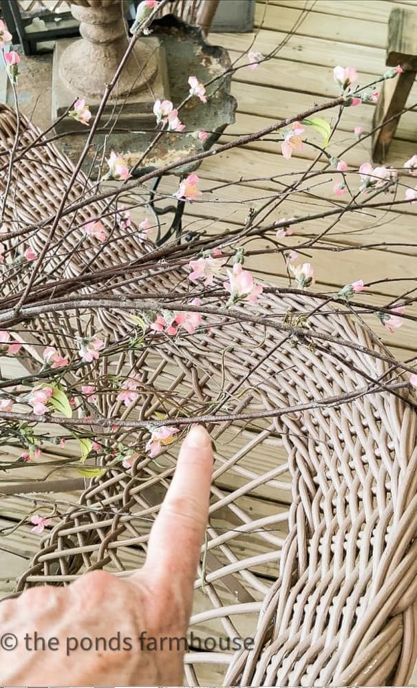 Add faux cherry blossom stems to gathered foraged tree branches.