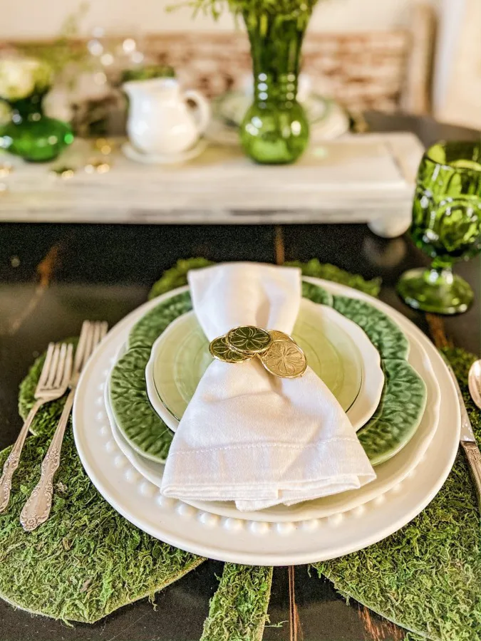 Gold coin napkin ring made from Dollar Tree coins and shamrock placemat with add green moss.