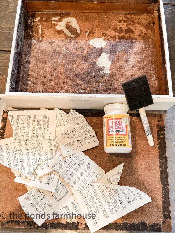 Remove the insides of the old silverware box to upcycle it into a farmhouse style stationary box. 