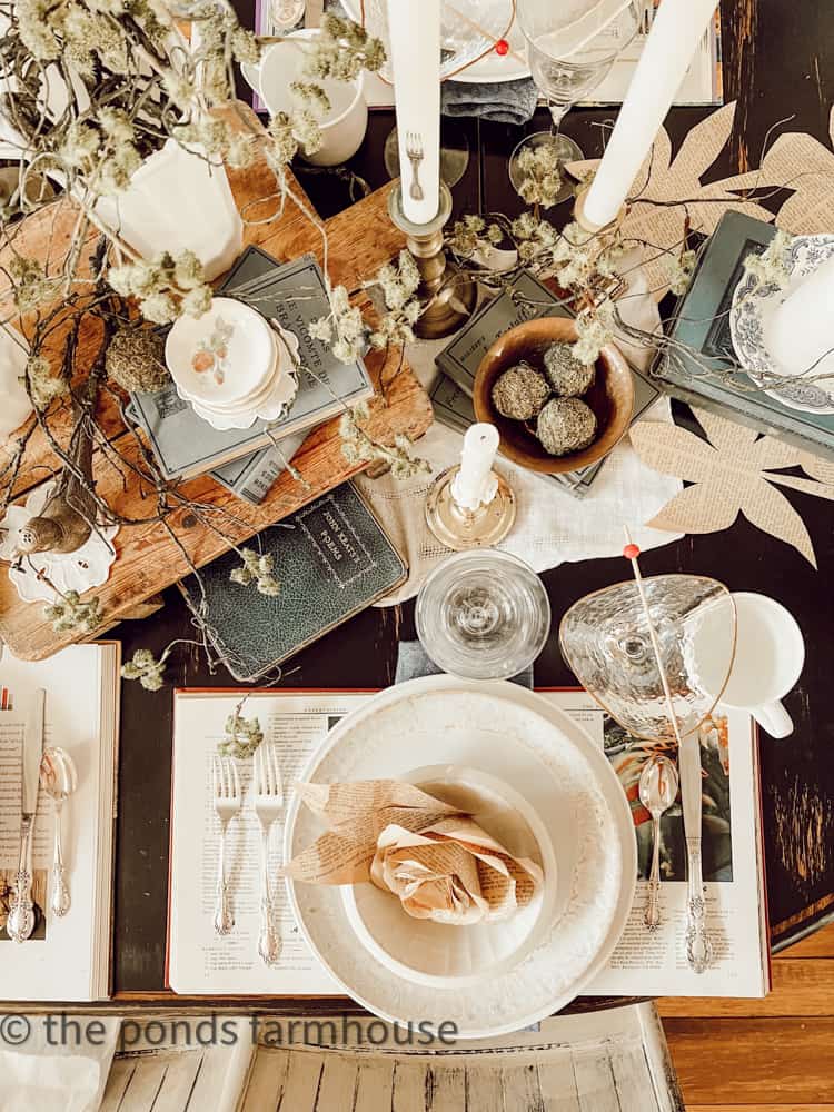 Vintage books and old paper pages add charm to a book club brunch table theme. 