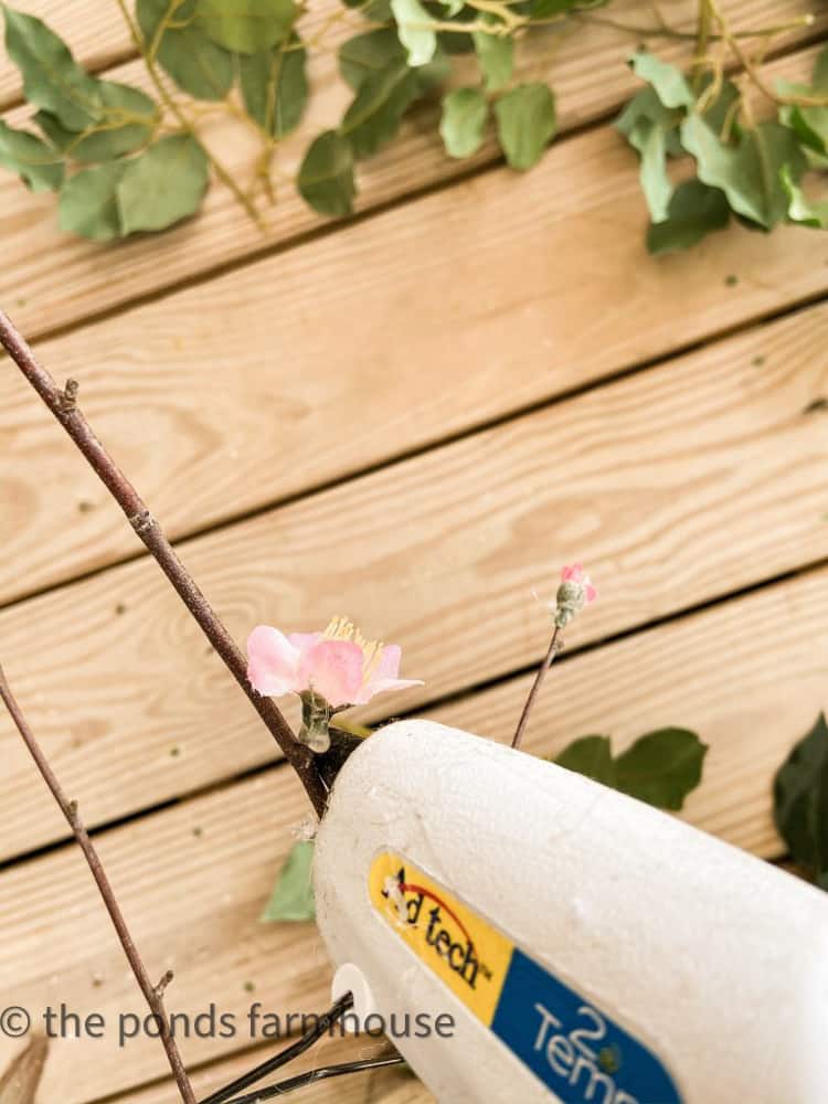 use hot glue to attach cherry blossom stems for ficus tree update